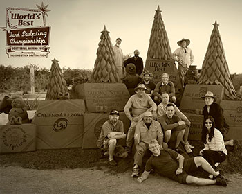 Image of a sand scultpture with christmas trees and snowman