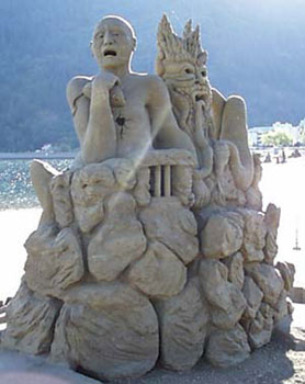 Abstract sand sculpture of a man and another being