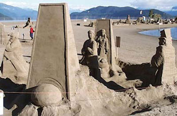 Abstract sand sculpture of a man standing in the middle of four abstract beings