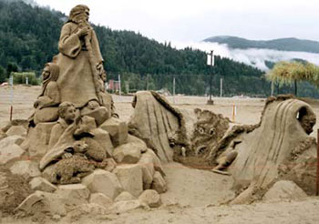 Abstract sculpture of family with a sheep standing on top of rocks
