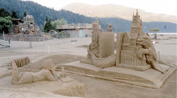 Sculpture of child staring at a castle and dragon which are jumping out of a book