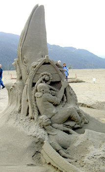 Abstract sculpture of a man and women in a dinghy, with a large fish in the background