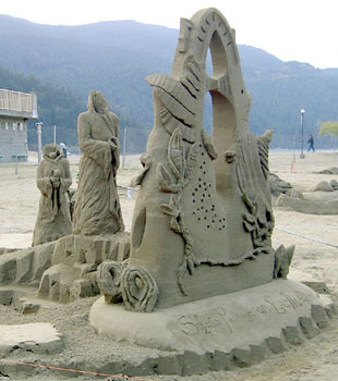 Headless people wait in line to reach an alter in this sand sculpture