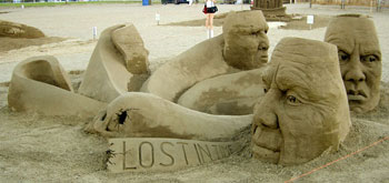 Sculpture of faces in a circle and a banner reading lost in time