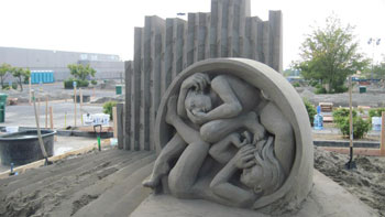 Abstract sculpture of man and woman inside a circle