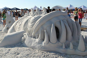 Abstract sand carving resembling a large fish with teeth