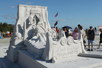 Sculpture of a person uneasily resting on a bed