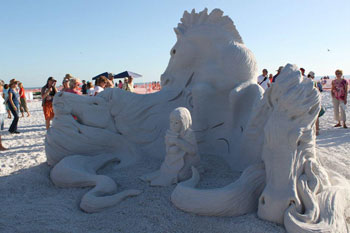 Abstract sculpture of a child and the head's of three horses
