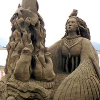 Detailed sand sculpture resembling a winged women staring upward