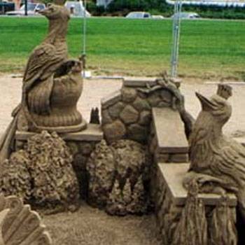 Image featuring multiple small sand sculptures being displayed under a tent