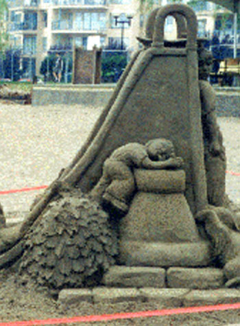 Image of a sculpture that shows a young child resting against a wall