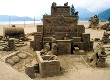 Large sand sculpture depicting a desk which appears to be a ticketing office