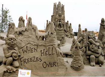 Sand sculpture depicting numerous non-human beings with a sign in the foreground stating: when hell freezes over