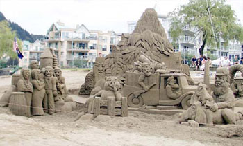 Sand sculpture depicting a military truck, a group of people, a personified animal, and an elderly man